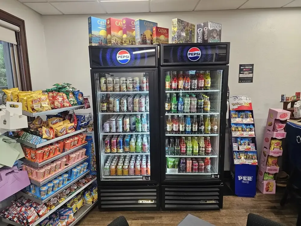 Rotating soda coolers, snack racks, and imported snacks at The Raft